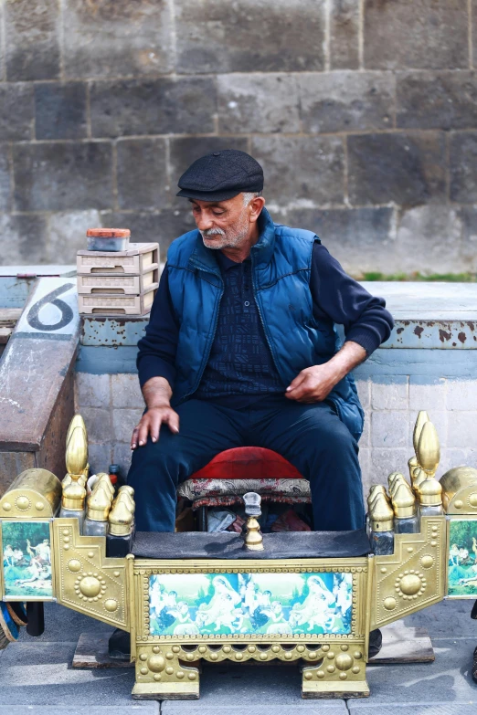 an old man sitting on a small toy train