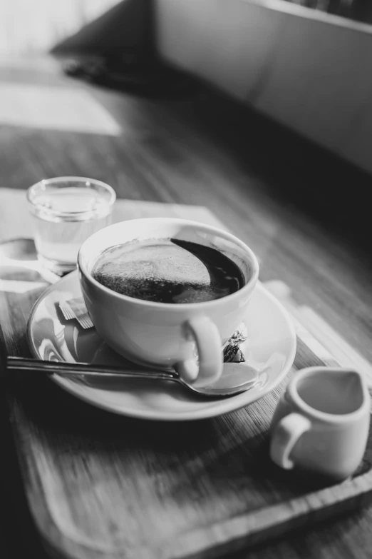 there is an empty plate on the table with cups of coffee