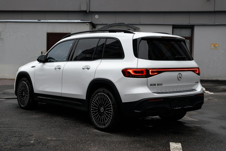 the rear end of a white suv with black trim