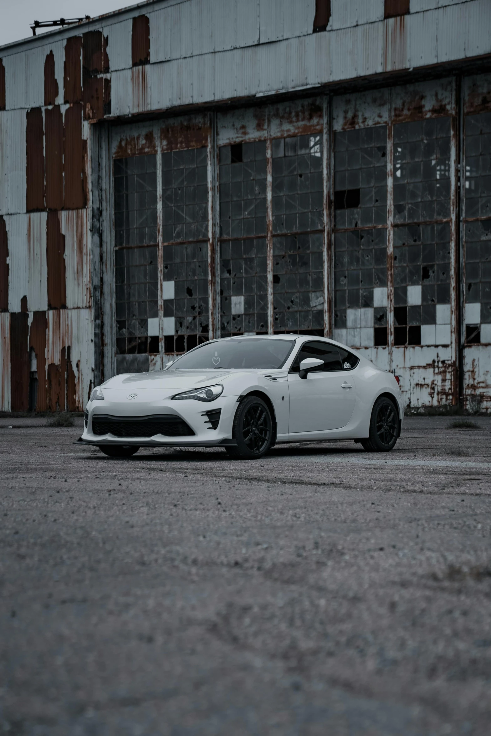 a car parked in front of an abandoned building