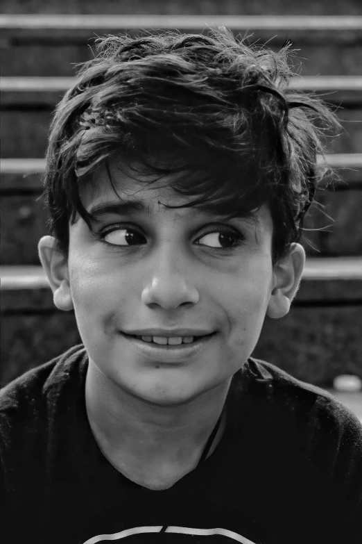 a boy with a mustache smiling at the camera