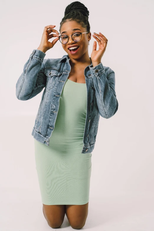 a woman in a green dress wearing glasses