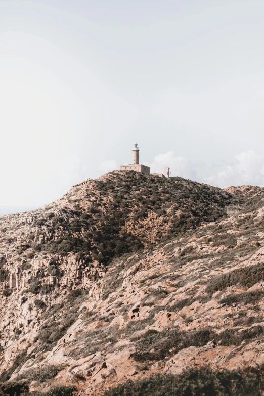 a small tower perched on the side of a hill