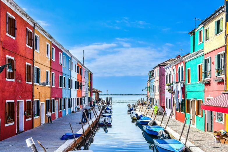 a colorful building is down by the water and is surrounded by other colorful buildings