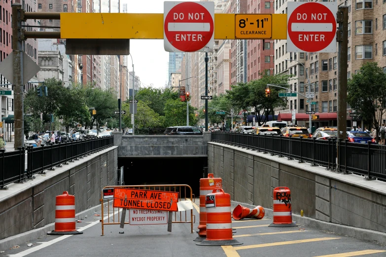 a city street filled with traffic and construction signs