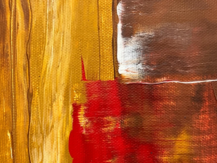 a close up po of yellow, red, and silver paint