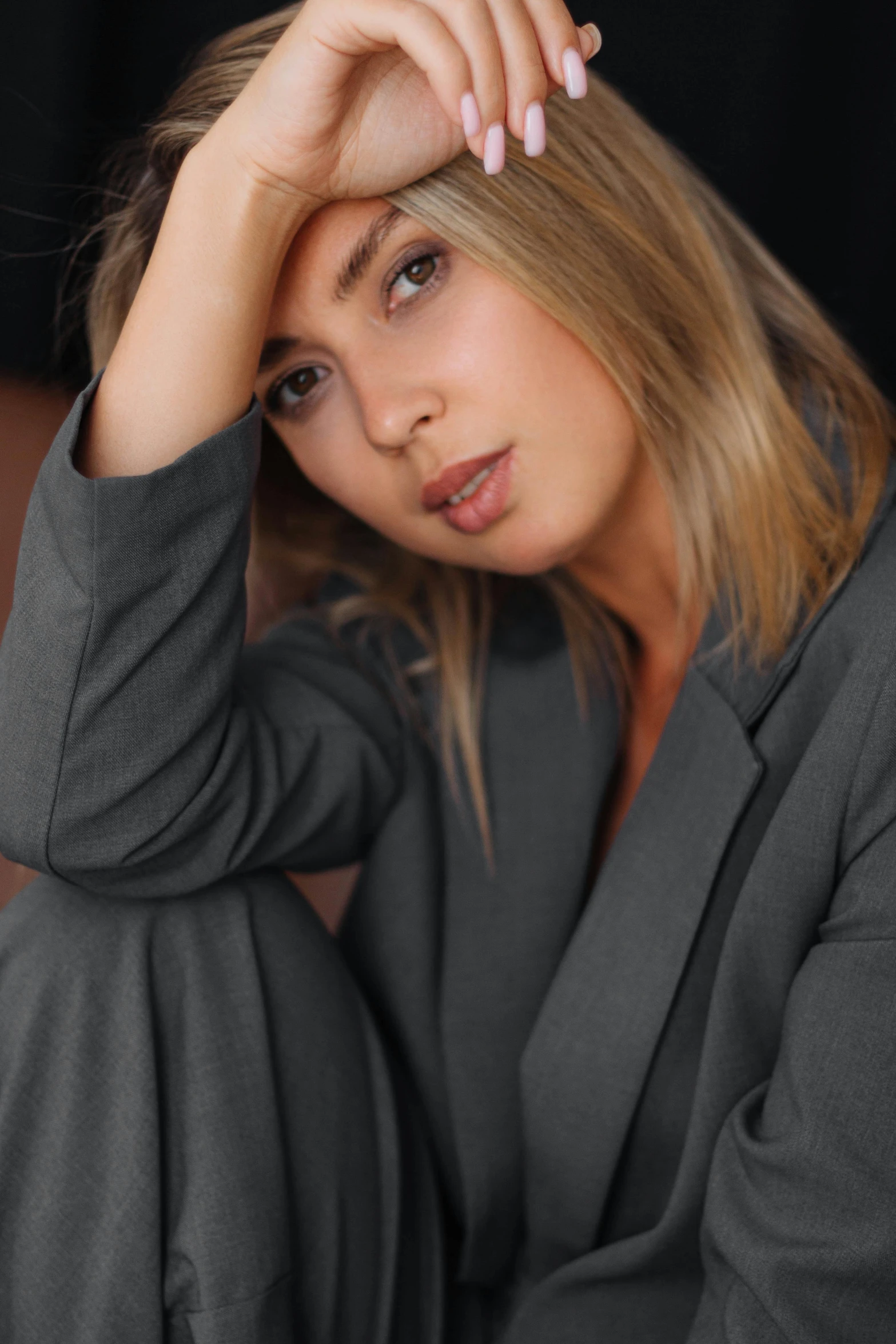 a woman with blonde hair wearing a gray suit