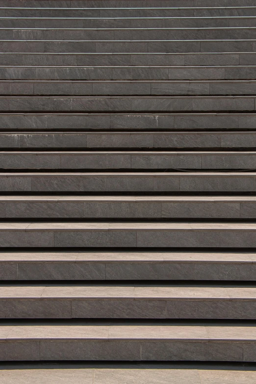 a person on a bench sitting and using his cell phone