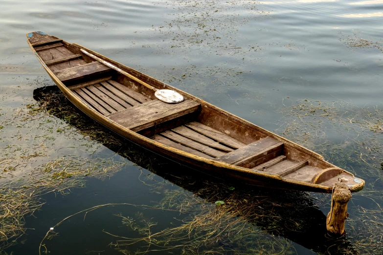 the empty row boat floats on the still water