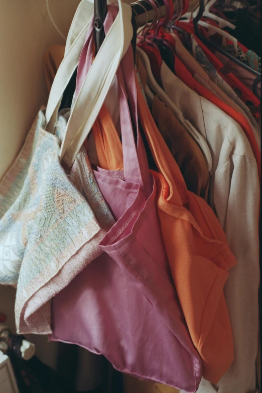 a closet filled with colorful clothing and a lot of clothes