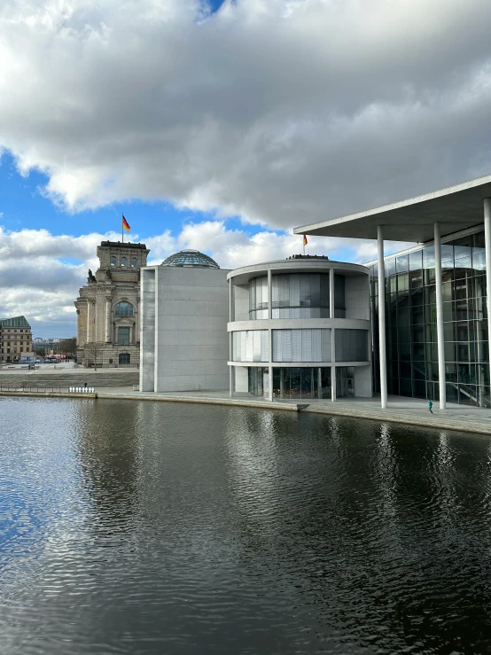 an open body of water sits next to several buildings