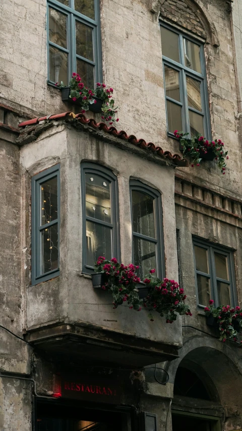 a building with several windows that are decorated with flowers