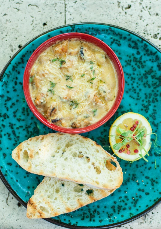 soup served on bread with a slice of lemon