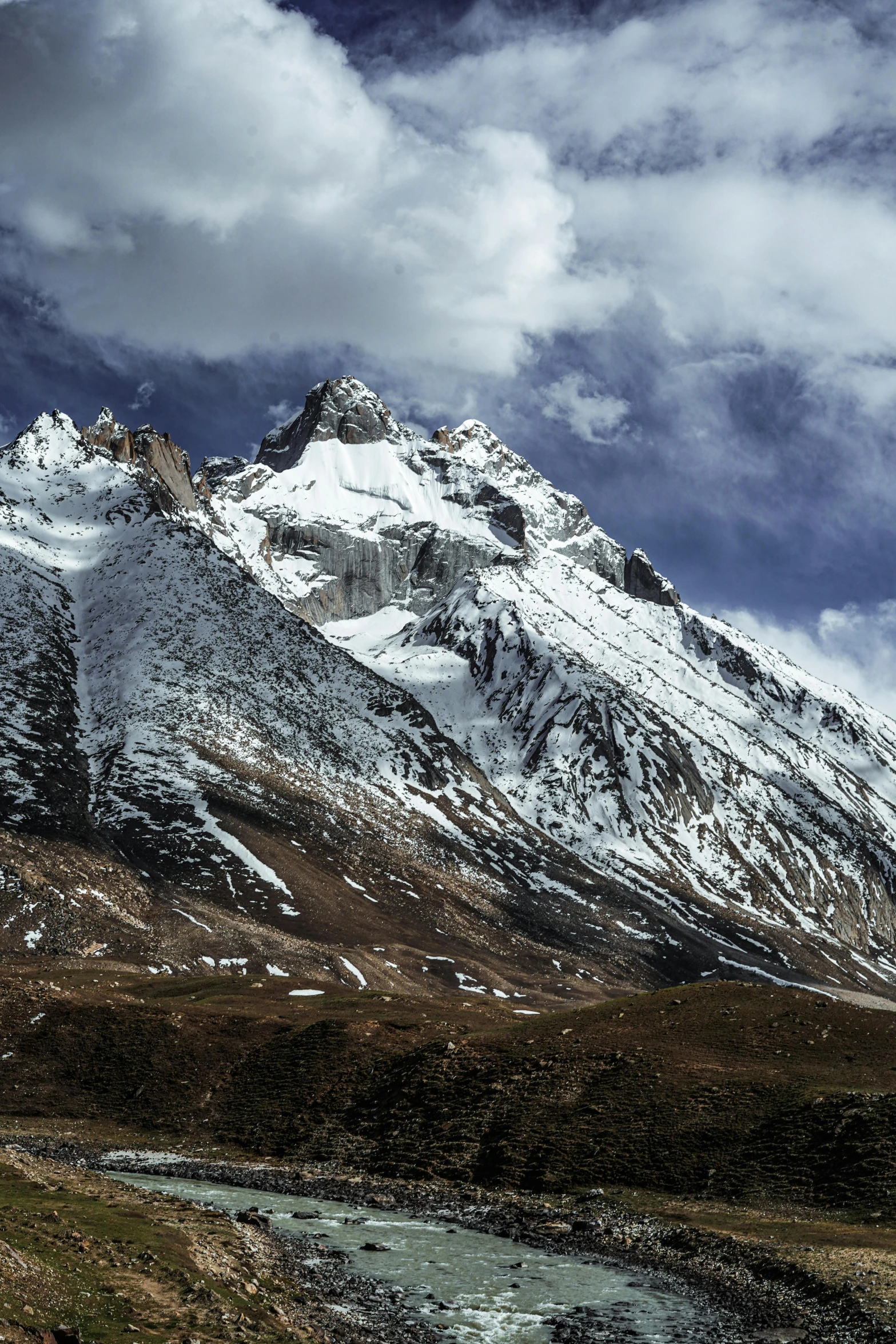 snow covered mountains rising above a river