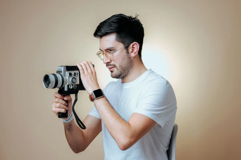 a man holding a camera taking pictures with it