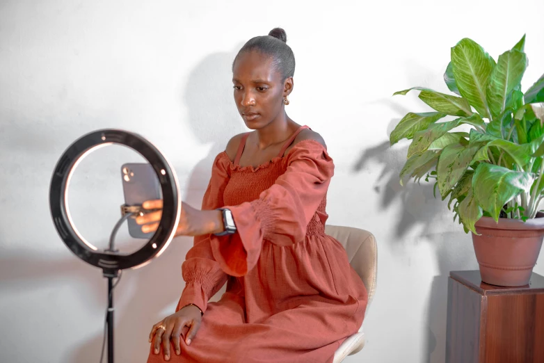 a woman sitting in a chair while looking at the mirror