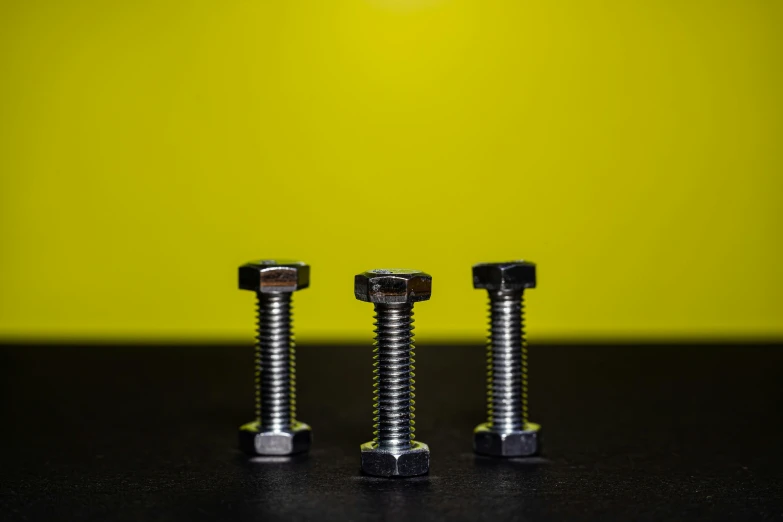 two metal bolts sit next to each other