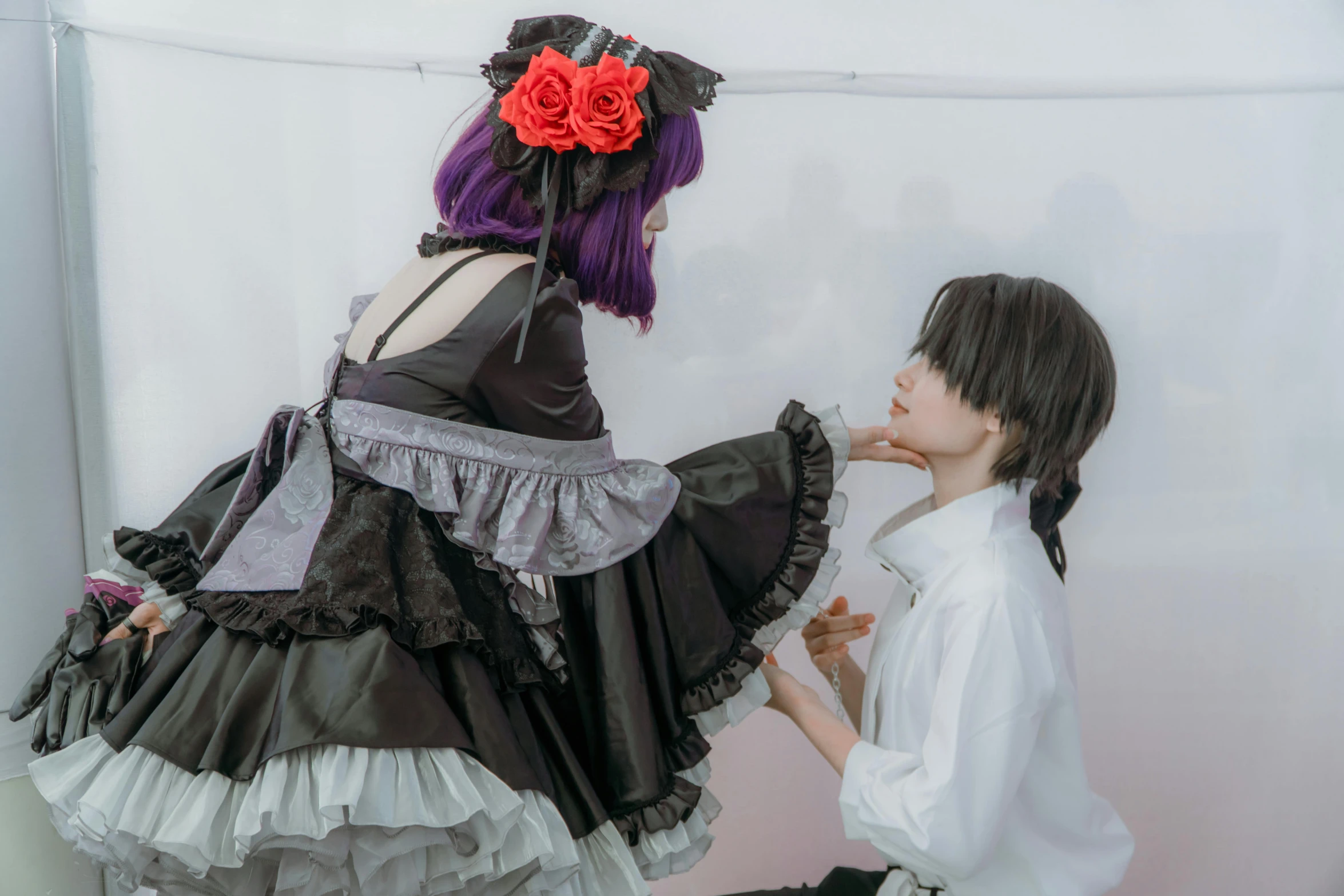 two women dressed in black and white dresses