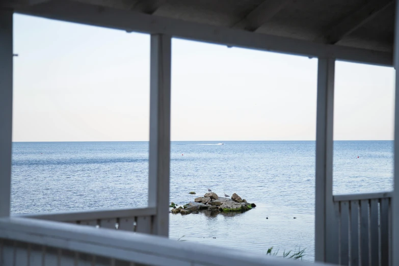 looking out the front of a building onto a body of water