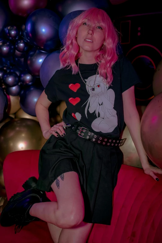 pink haired girl sitting on the back of a couch