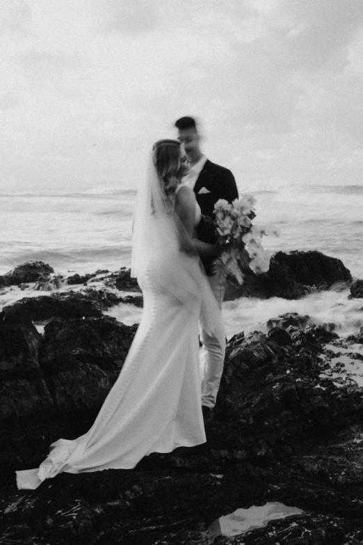 a bride and groom pose for a po