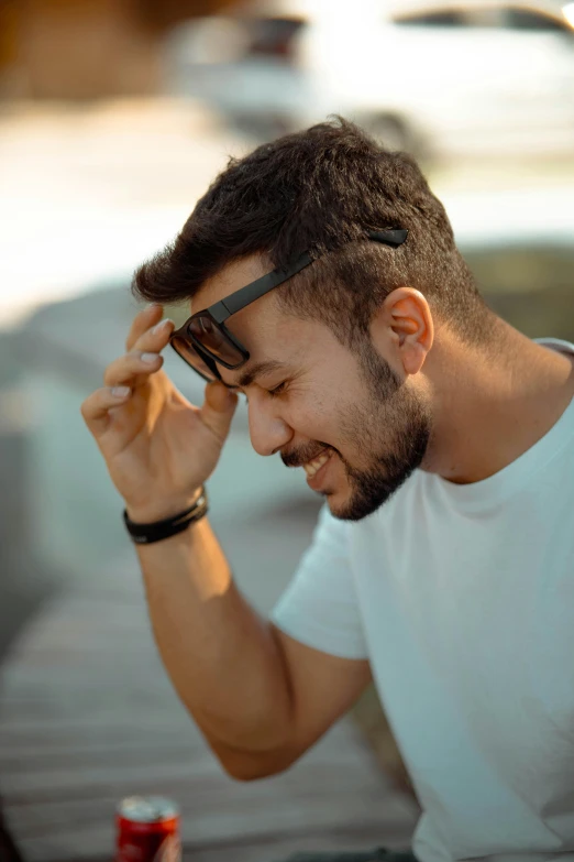 a man with sunglasses is sitting down