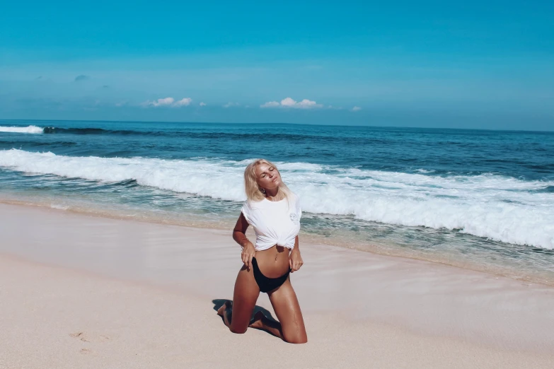 young woman posing on the beach in bikini