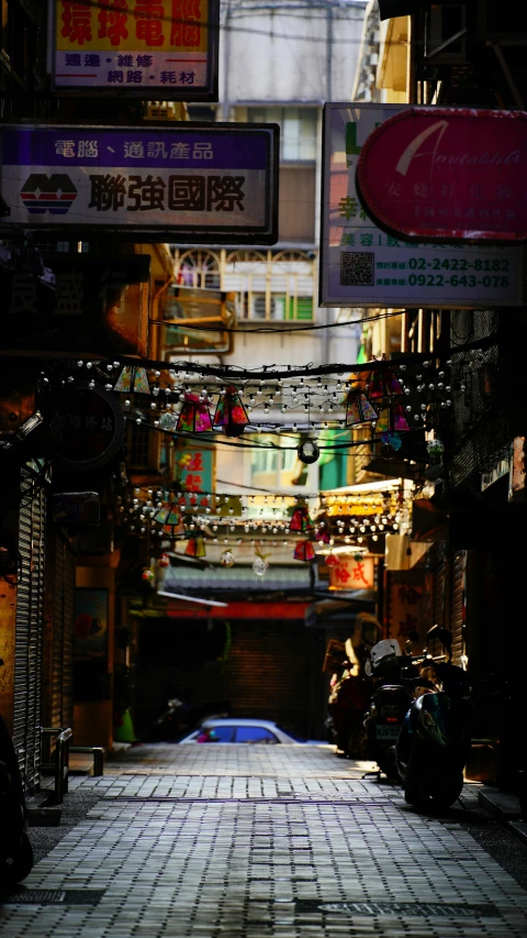 an oriental alley with signs, lights and a car