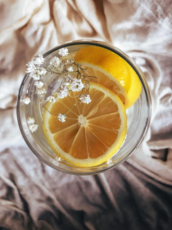 a sliced orange sits on top of a bowl