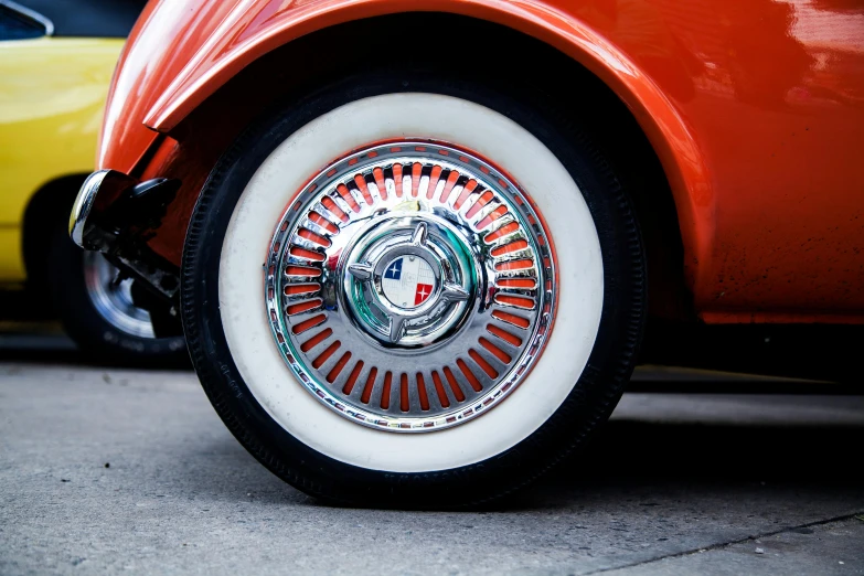 the wheel of a classic car, with an ornate design on the rim