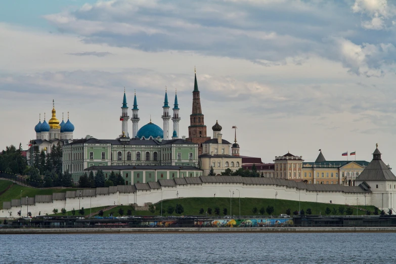 a large building near the water and some people on a boat