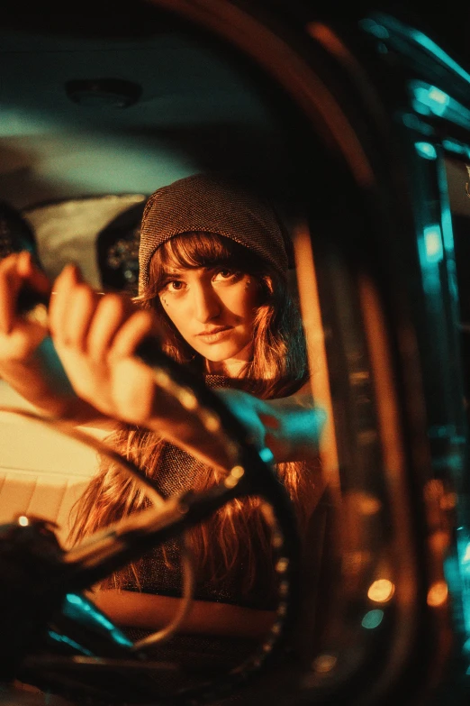 a woman taking a selfie in the car mirror