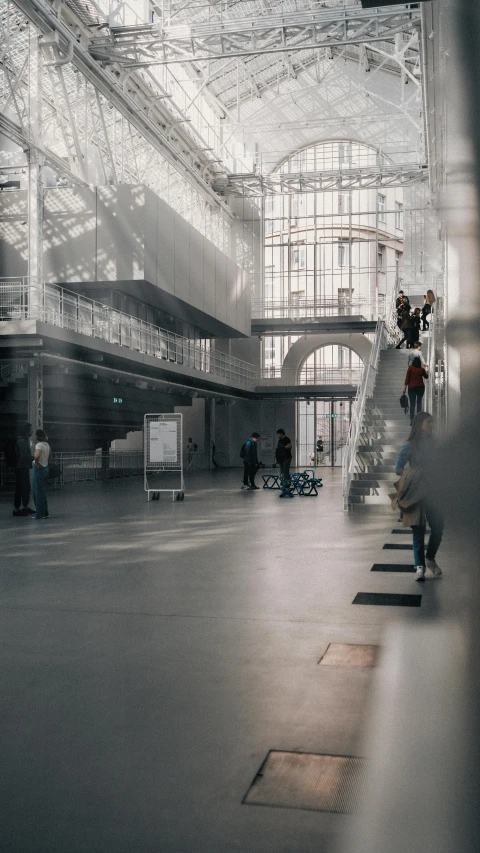 a group of people stand on a staircase inside a building