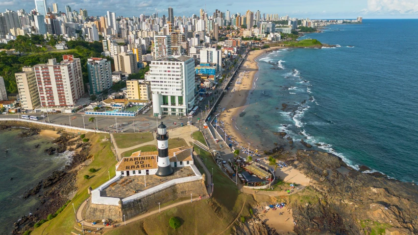 the view from above of an area with buildings and water in the background