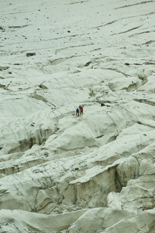 two people are walking through the desert on horses