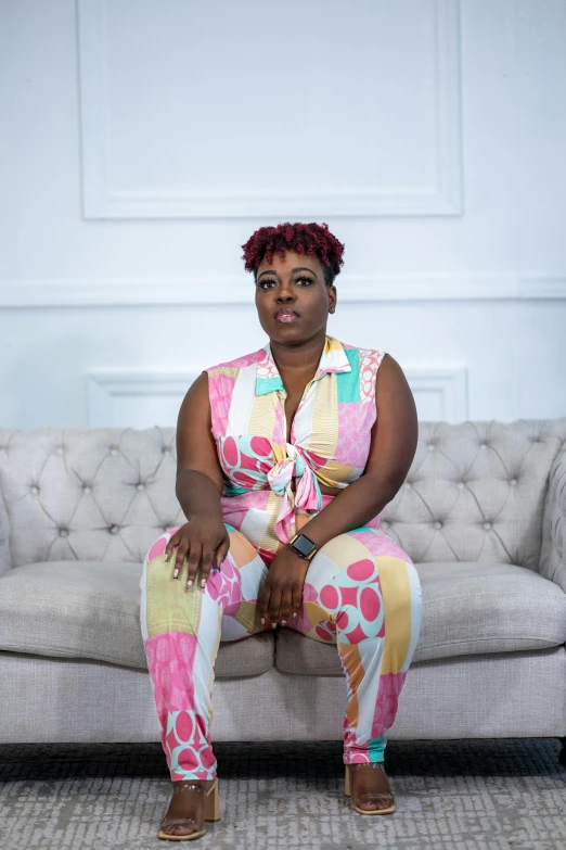 an overweight african american woman sitting on a sofa