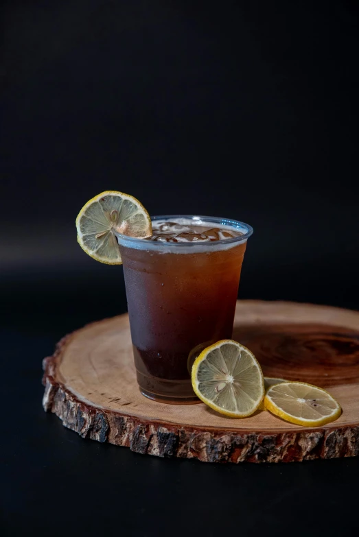 a glass filled with a beverage with lemons