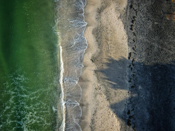 an overhead view of a beach and ocean