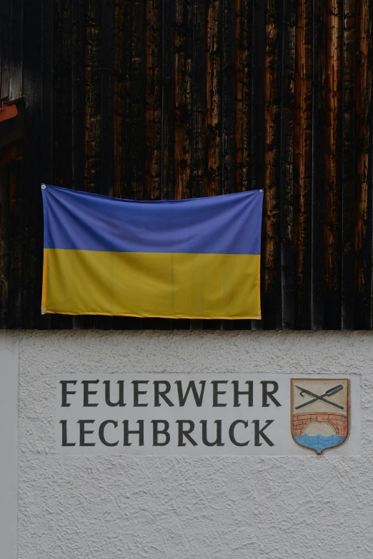 the outside of a building has an ukraine flag and two european flags