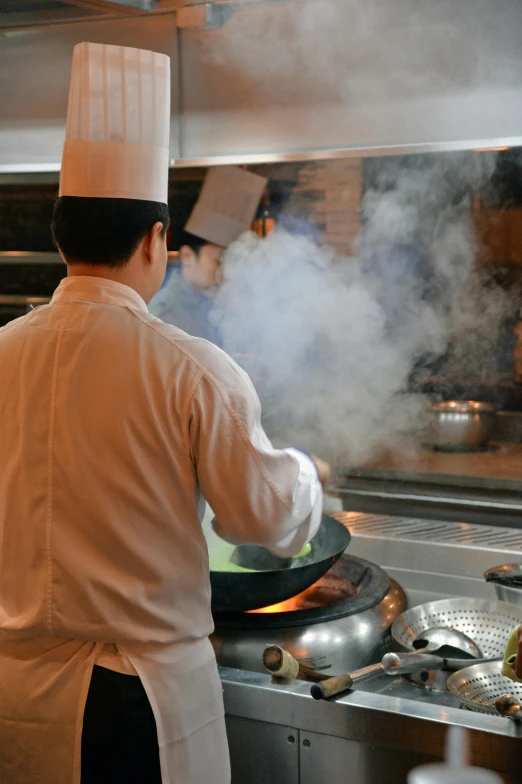 a chef is cooking a meal in the kitchen