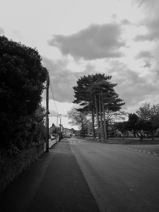 a dark street with a sign on the side of it