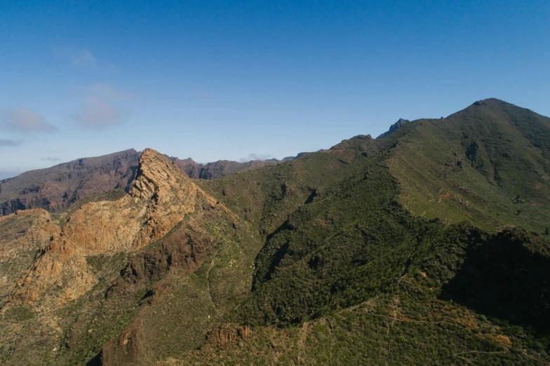 mountains and a clear sky with only some clouds in them