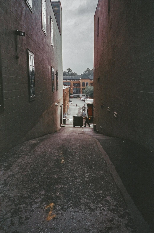 a dark street lined with tall, brick buildings