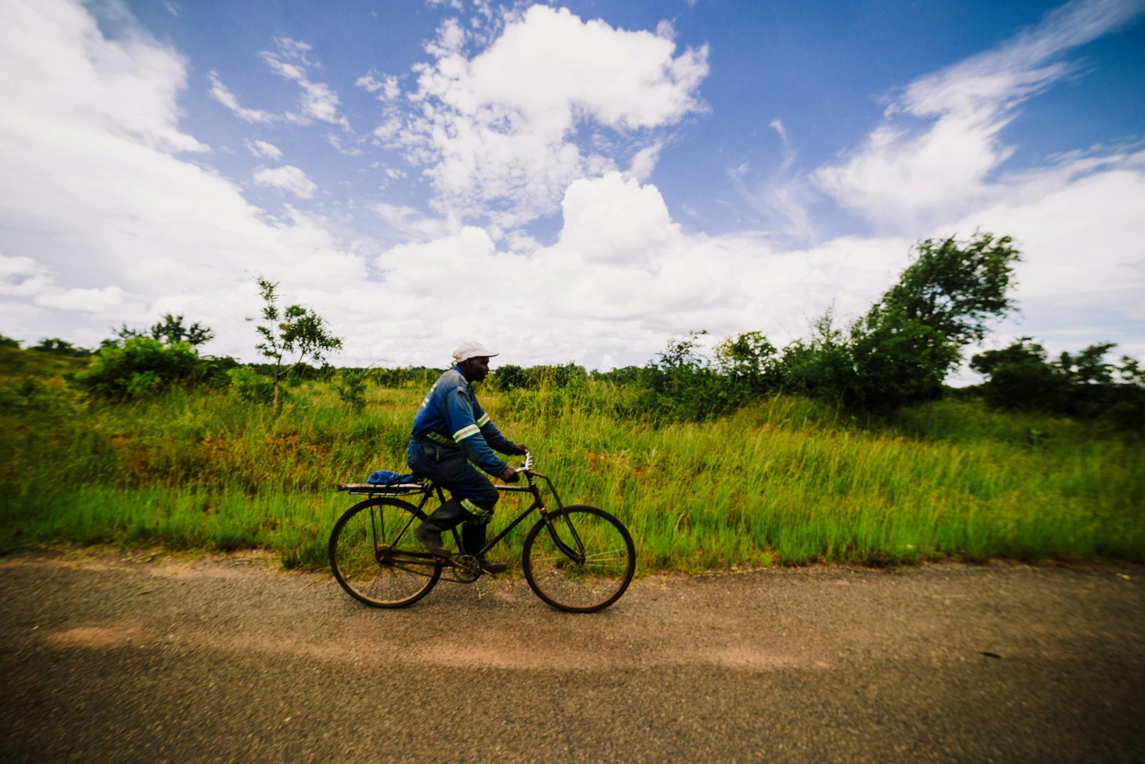 a man riding his bike in the grass