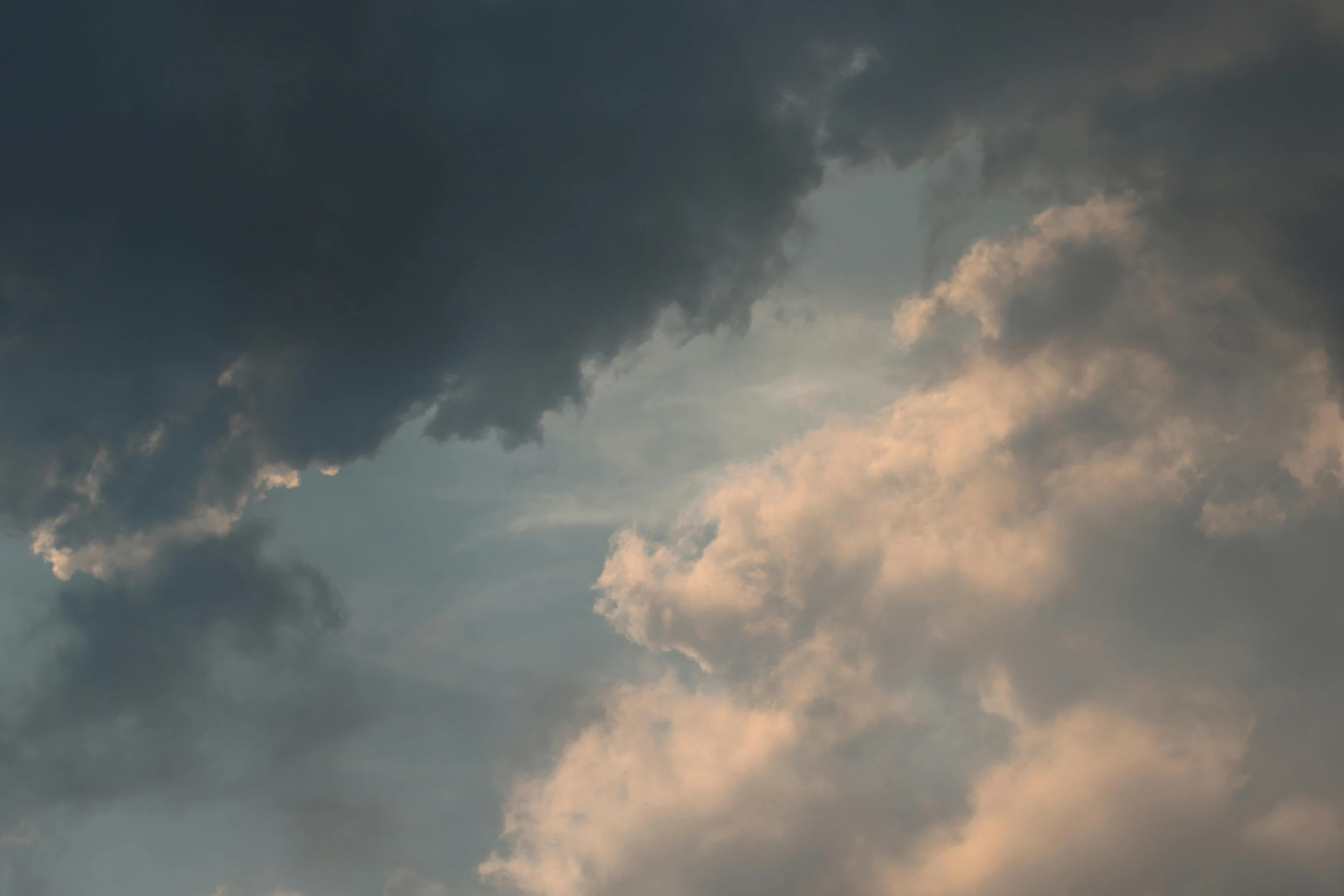 a big plane flying over a cloudy sky