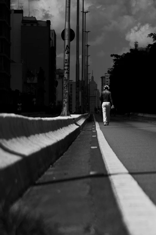 a person walking down the side walk in a city