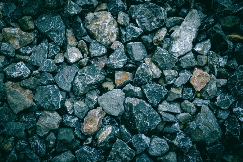 a group of rocks covered with water and dirt