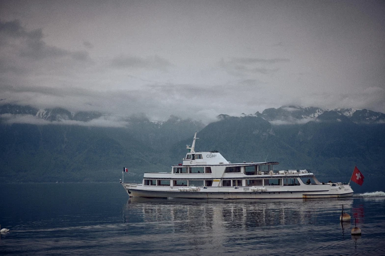 a big white boat out in the ocean on a cloudy day