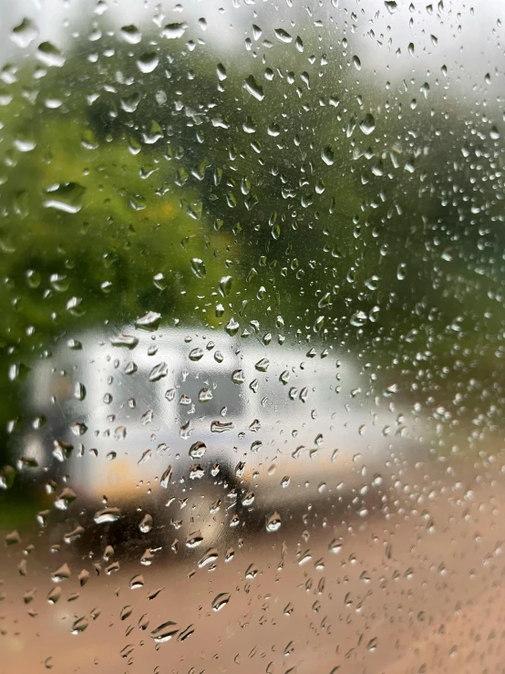 rain is pouring down on the window pane