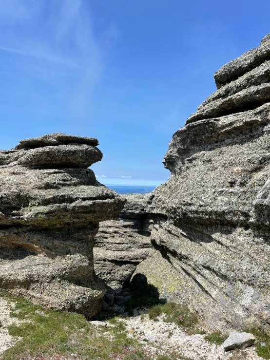 a person standing in the distance looking at rocks